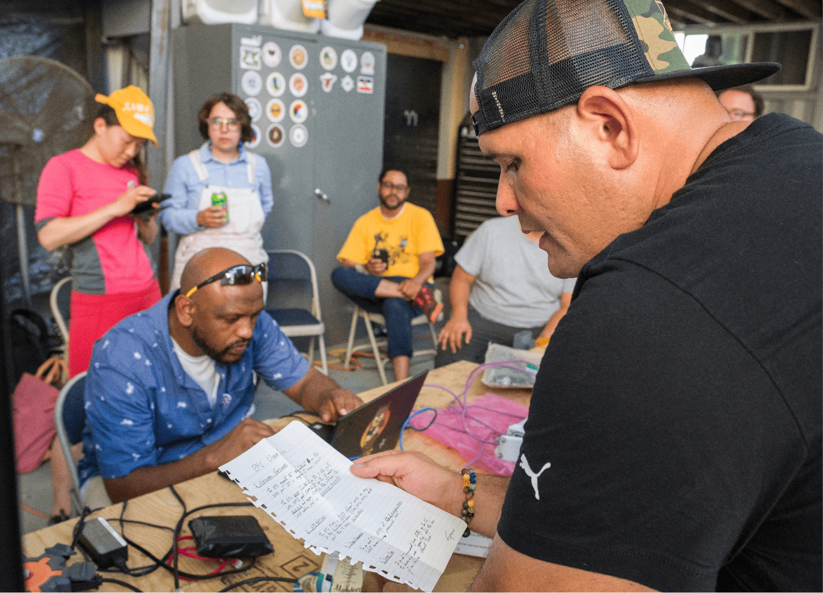 Native Hawaaiian man reads out network configuration instructions at a Tribal Broadband Bootcamp.